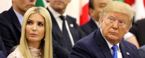 Advisor to the US President Ivanka Trump (L) sits next to her father US President Donald Trump during an event on the theme 