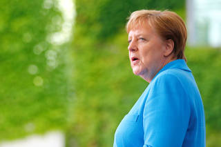 German Chancellor Angela Merkel welcomes Ireland's President Michael D. Higgins at the Chancellery in Berlin