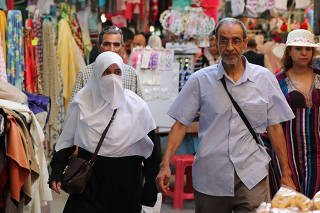 A woman walks in the old city of Tunis