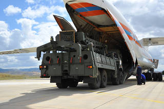 First parts of a Russian S-400 missile defense system are unloaded from a Russian plane at Murted Airport near Ankara