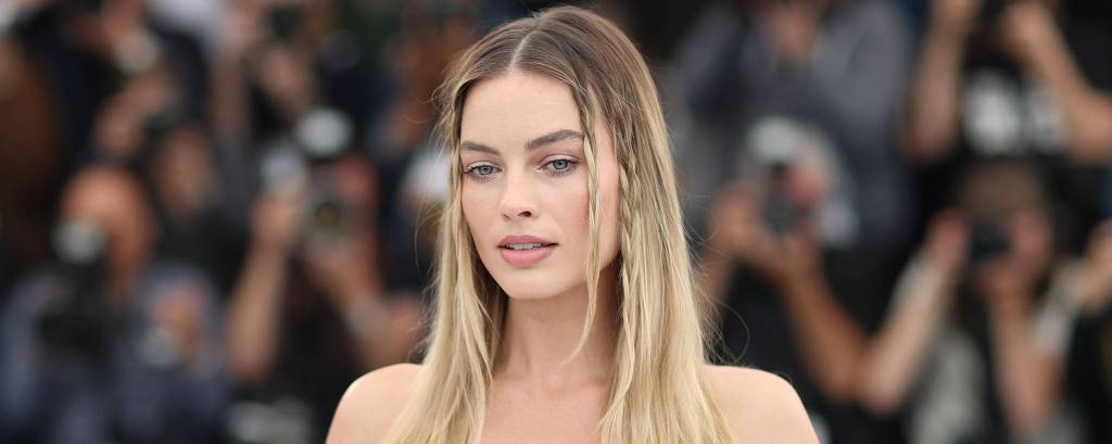 Atriz Margot Robbie posa com diversas roupas da boneca Barbie em