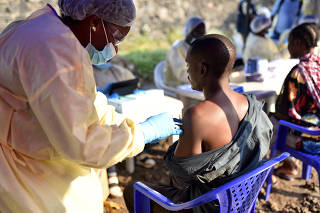 A Congolese health worker administers an ebola vaccine to a man at the Himbi Health Centre in Goma