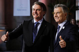 Argentina's President Mauricio Macri and his Brazilian counterpart Jair Bolsonaro pose at the 54th Summit of Heads of State of Mercosur and Associated States, in Santa Fe