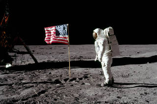 Buzz Aldrin poses for a photograph beside the deployed United States flag on the moon