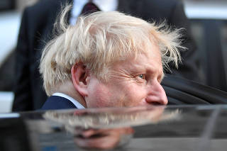 Boris Johnson, leader of the Britain's Conservative Party, leaves a private reception in central London