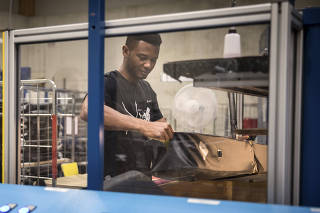 Abdoulie Barry, a 37-year-old from Gambia whose asylum claim was rejected, working at Vaude in Tettnang, Germany, July 11, 2019.  (Gordon Welters/The New York Times)