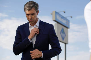 Democratic presidential candidate Beto O'Rourke embraces Patricia Olivera a relative of one of the survivors at the site of a mass shooting where 20 people lost their lives at a Walmart in El Paso