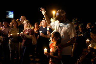 Mourners attend a candle light vigil after a mass shooting at the First Baptist Church in Sutherland Springs