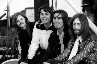 Members of the Beatles pose in Twickenham