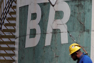 A worker stands near a tank of Brazil's state-run Petrobras oil company in Brasilia