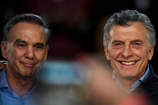 Argentine President Mauricio Macri poses next to his running mate Miguel Angel Pichetto, during a closing campaign rally ahead of primary elections, in Buenos Aires