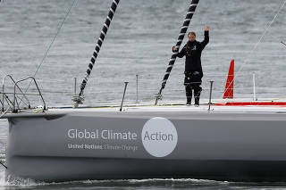 Swedish teenage climate activist Greta Thunberg waves from a yacht as she starts her trans-Atlantic boat trip to New York, in Plymouth