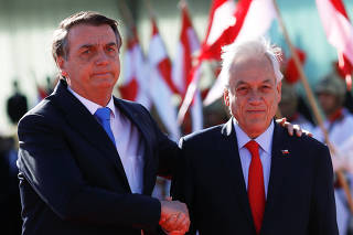 Brazil's President Jair Bolsonaro greets Chile's President Sebastian Pinera at the Alvorada Palace in Brasilia