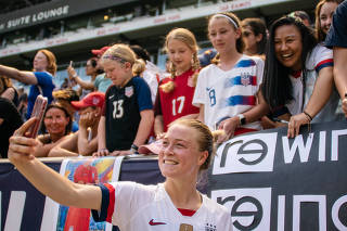 Abby Dahlkemper, with the U.S. women's soccer team, takes a selfie with fans after a match with Mexico, at Red Bull Arena in Harrison, N.J., May 26, 2019. (Jeenah Moon/The New York Times)