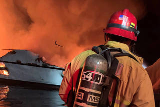 Ventura County Fire Department personnel respond to a boat fire off Santa Cruz Island