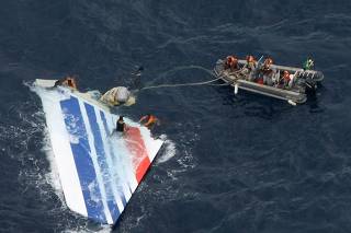 File photo of Brazilian Navy sailors picking a piece of debris from Air France flight AF447 out of the Atlantic Ocean