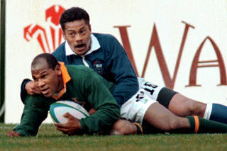 FILE PHOTO: South African left wing Chester Williams scores the second try for his team June 10 during the quart..
