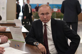 Russia's President Putin visits a polling station during the Moscow city parliament election in Moscow