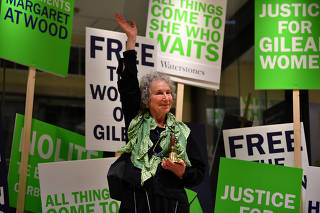 Author Margaret Atwood waves as she reads an extract during the launch of her new novel The Testaments at a book store in London, Britain