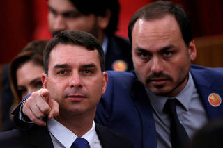 FILE PHOTO: Flavio Bolsonaro and Carlos Bolsonaro, sons of the Brazil's President-elect Jair Bolsonaro are seen before their father received a confirmation of his victory in the recent presidential election in Brasilia