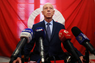 Presidential candidate Kais Saied speaks as he attends a news conference after the announcement of the results in the first round of Tunisia's presidential election in Tunis