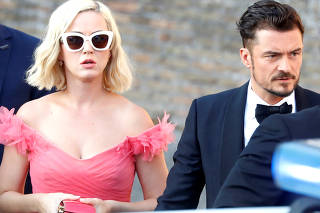 Singer Kate Perry and actor Orlando Bloom arrive to attend the wedding of fashion designer Misha Nonoo at Villa Aurelia in Rome