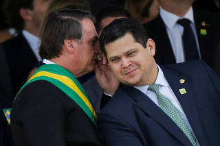 Brazil's President Jair Bolsonaro speaks with  Brazil's President of the Senate Davi Alcolumbre during a parade celebrating the country's Independence Day in Brasilia