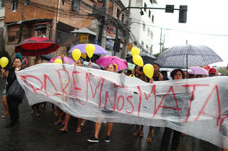 Residents march in memoriam of the 8-year-old Agatha Sales Felix, who was killed by a stray bullet, at the Alemao complex slum during a police operation in Rio de Janeiro