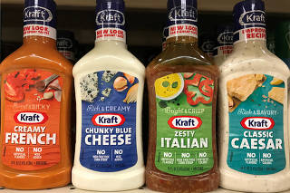 FILE PHOTO: Bottles of salad dressing made by food conglomerate Kraft Heinz are seen on a supermarket shelf in Seattle