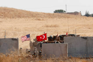 FILE PHOTO: Turkish and U.S. troops return from a joint U.S.-Turkey patrol in northern Syria, as it is pictured from near the Turkish town of Akcakale