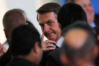 Brazil's President Bolsonaro gestures during a ceremony at the Planalto Palace in Brasilia