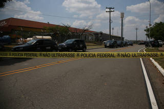 The entrance of the Viracopos airport freight terminal is seen blocked after an armed gang robbed a securities company in Campinas