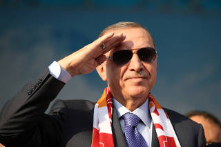 Turkish President Erdogan salutes during a gathering in Kayseri