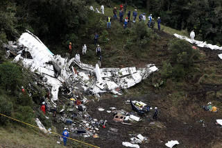 Rescue crew work at the wreckage of a plane that crashed into the Colombian jungle with Brazilian soccer team Chapecoense onboard near Medellin