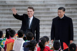 Brazilian President Jair Bolsonaro greets next to Chinese President Xi Jinping during a welcoming ceremony in Beijing