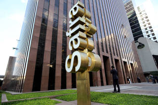 FILE PHOTO: A man walks in front of the  Banco Safra SA headquarter in Sao Paulo