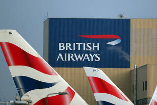 FILE PHOTO: British Airways logos are seen on tail fins at Heathrow Airport in west London