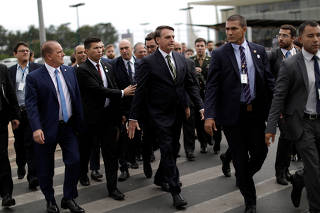 Brazil's President Jair Bolsonaro leaves the Planalto Palace to deliver the economic reform package to National Congress, in Brasilia