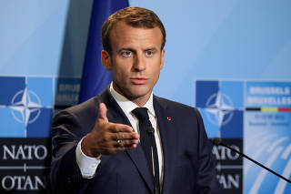 FILE PHOTO: French President Emmanuel Macron addresses a press conference on the second day of the North Atlantic Treaty Organization (NATO) summit in Brussels