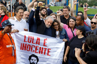 Former Brazilian President Luiz Inacio Lula da Silva walks out after being released from prison, in Curitiba