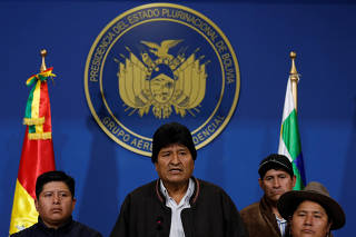 Bolivia's President Evo Morales addresses the media at the presidential hangar in the Bolivian Air Force terminal in El Alto