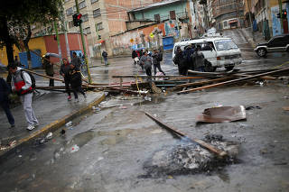 Ashes from a campfire in front of the remains of a barricade are seen around the Murillo square, in La Paz