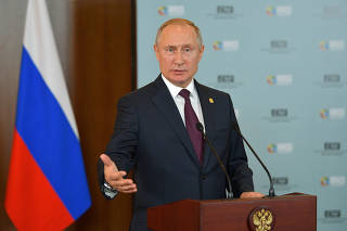 Russian President Vladimir Putin speaks at a news conference after the BRICS summit in Brasilia