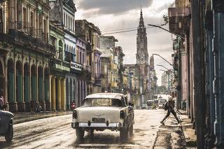 Typical street in La Habana and cathedral in the distance in rain, Havana, Cuba, West Indies, Caribbean, Central America