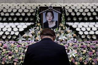 A man pays tribute at a memorial altar as he makes a call of condolence in honour of the K-pop star Goo Hara at the Seoul St. Mary's Hospital in Seoul
