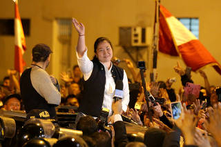 Peru's opposition leader Keiko Fujimori waves after being released from the Santa Monica prison, in Lima