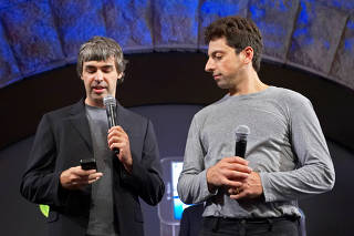 FILE PHOTO: Founders of Google show new G1 phone running Android software in New York