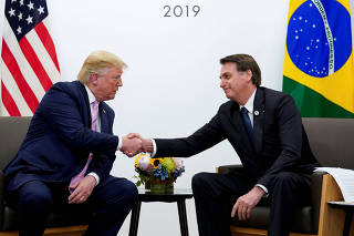 FILE PHOTO: U.S. President Trump and Brazil's Bolsonaro at G20 summit in Osaka in June