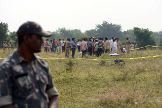 Police officials examine the site where police shot dead four men suspected of raping and killing a 27-year-old veterinarian, in Chatanpally on the outskirts of Shadnagar