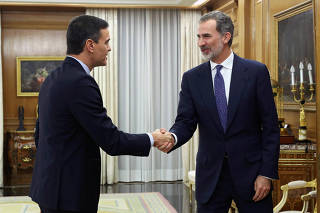Spain's King Felipe greets acting PM Sanchez before their meeting in Madrid